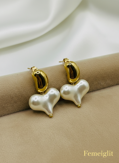 Pearl earrings with gold accents on a white surface