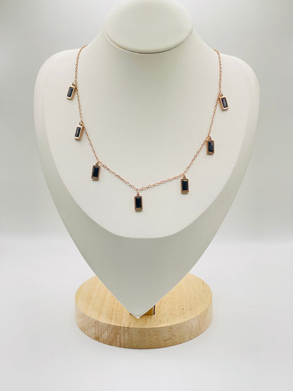 Rose gold Necklace with black stones on a white mannequin bust
