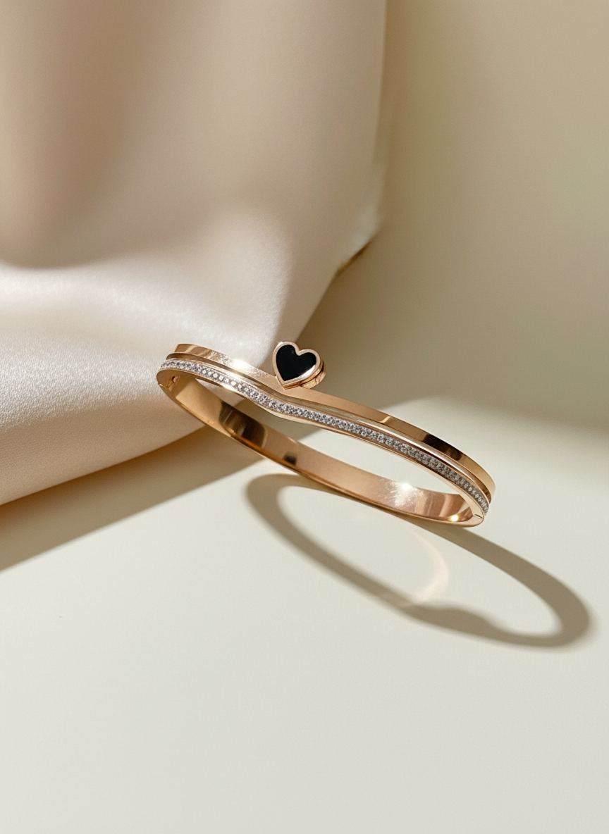 Rose gold ring with heart detail on a beige fabric background