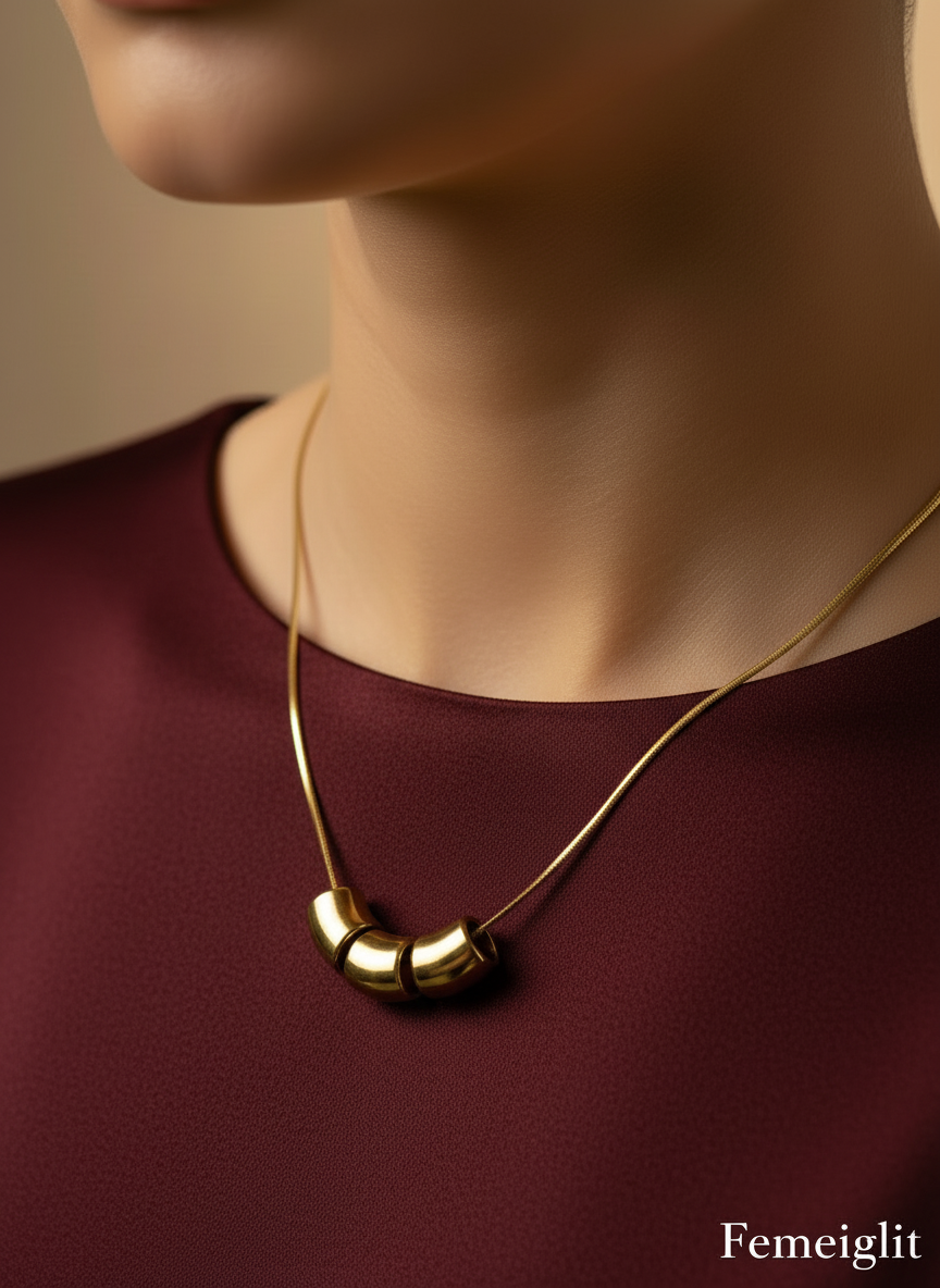 Gold necklace on a mannequin bust with a white background