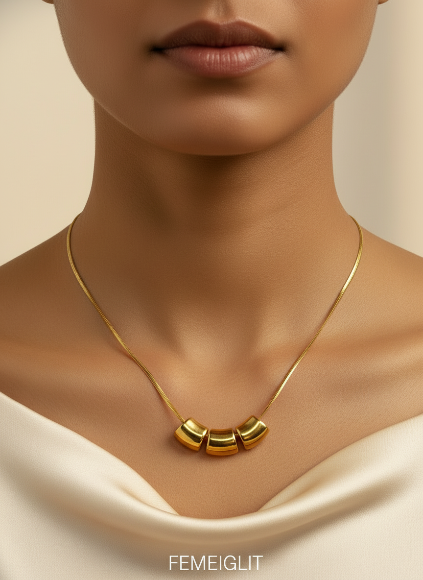 Gold necklace on a mannequin bust with a white background