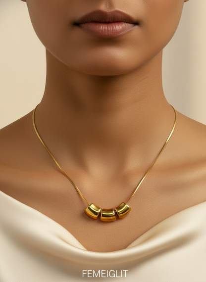 Gold necklace on a mannequin bust with a white background