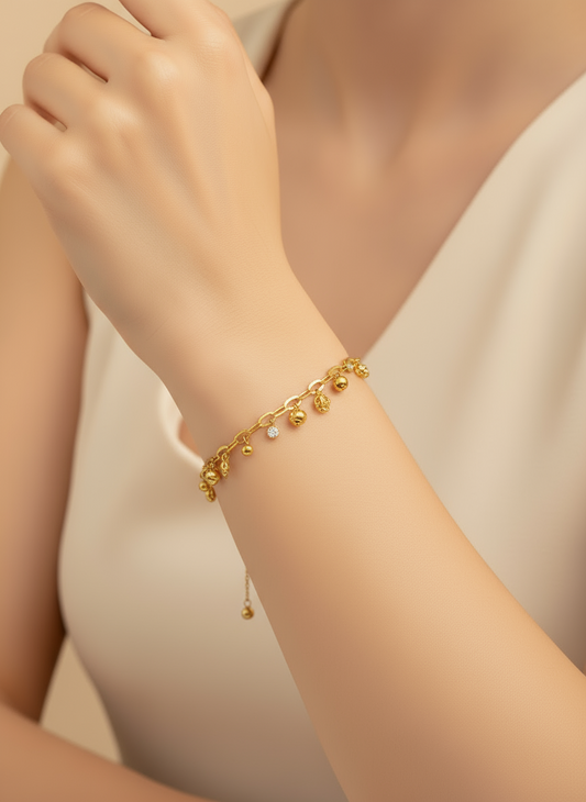 Gold bracelet on a white surface