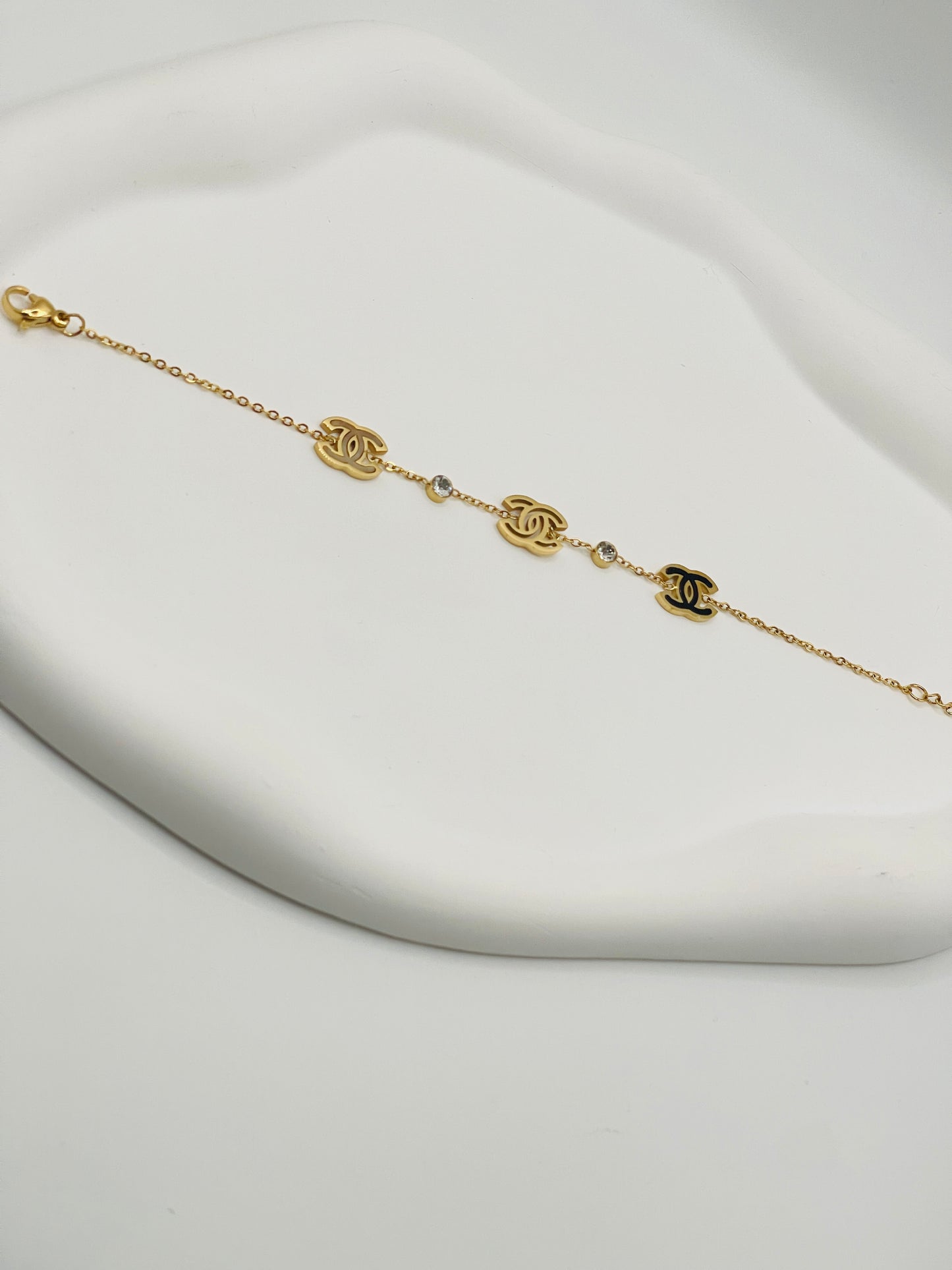 Gold bracelet with chain design on a white background