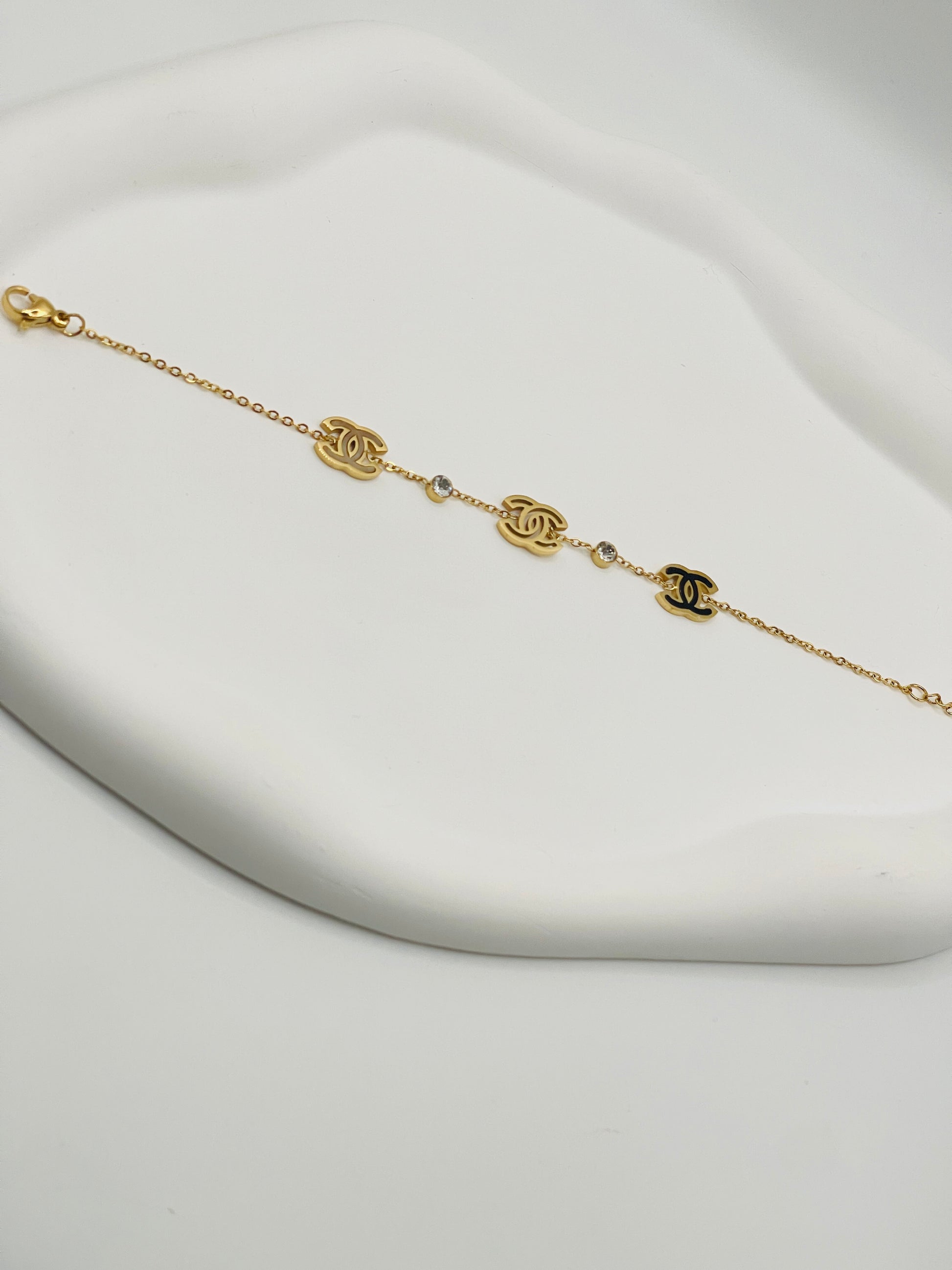 Gold bracelet with chain design on a white background