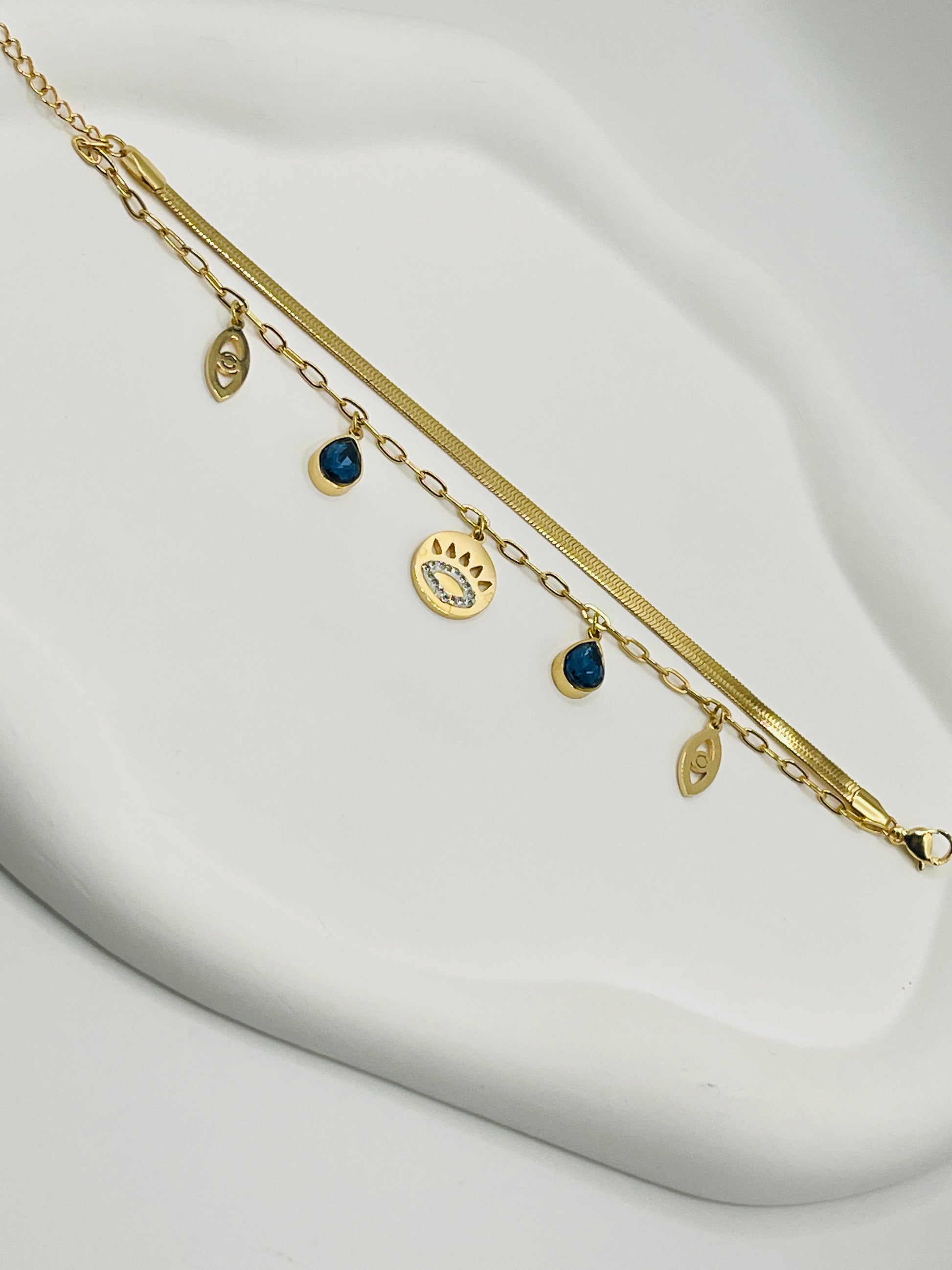 Gold braceletwith charms on a white background