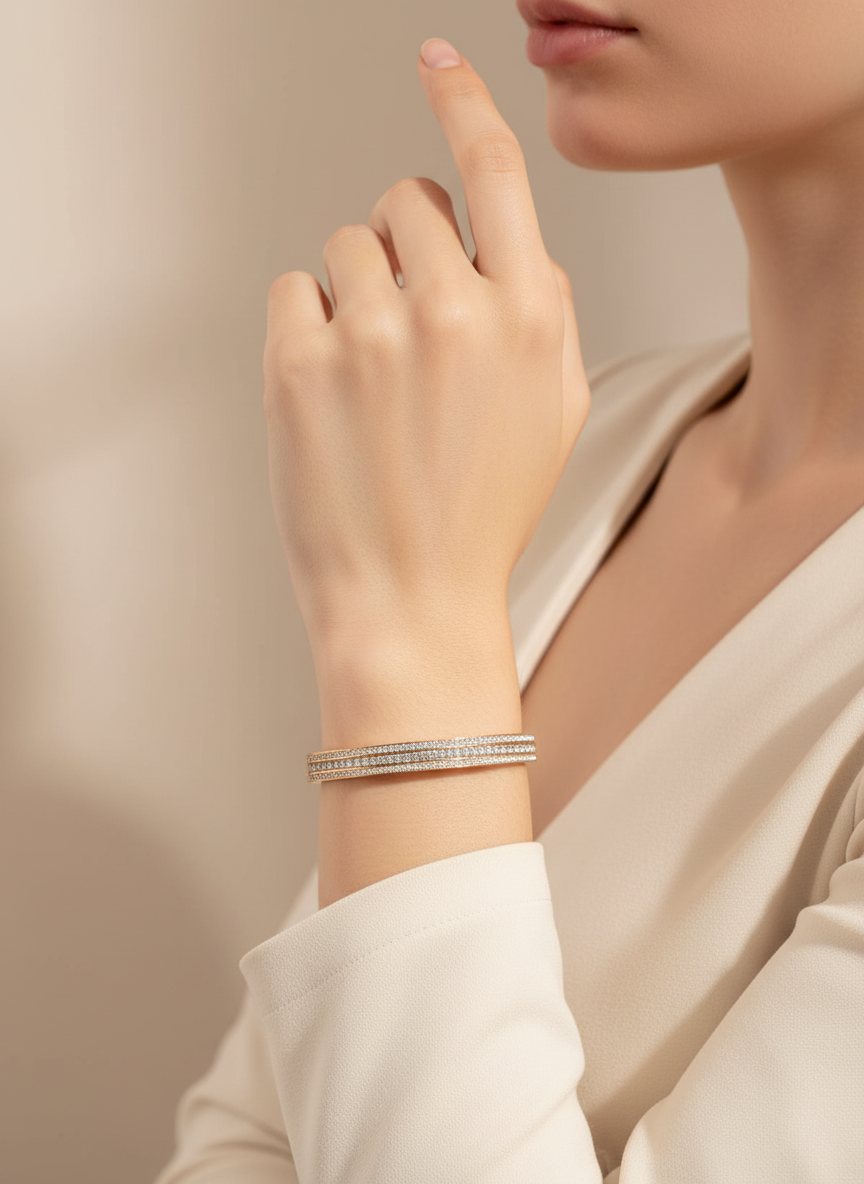 Close-up of a hand wearing a bracelet on a neutral background