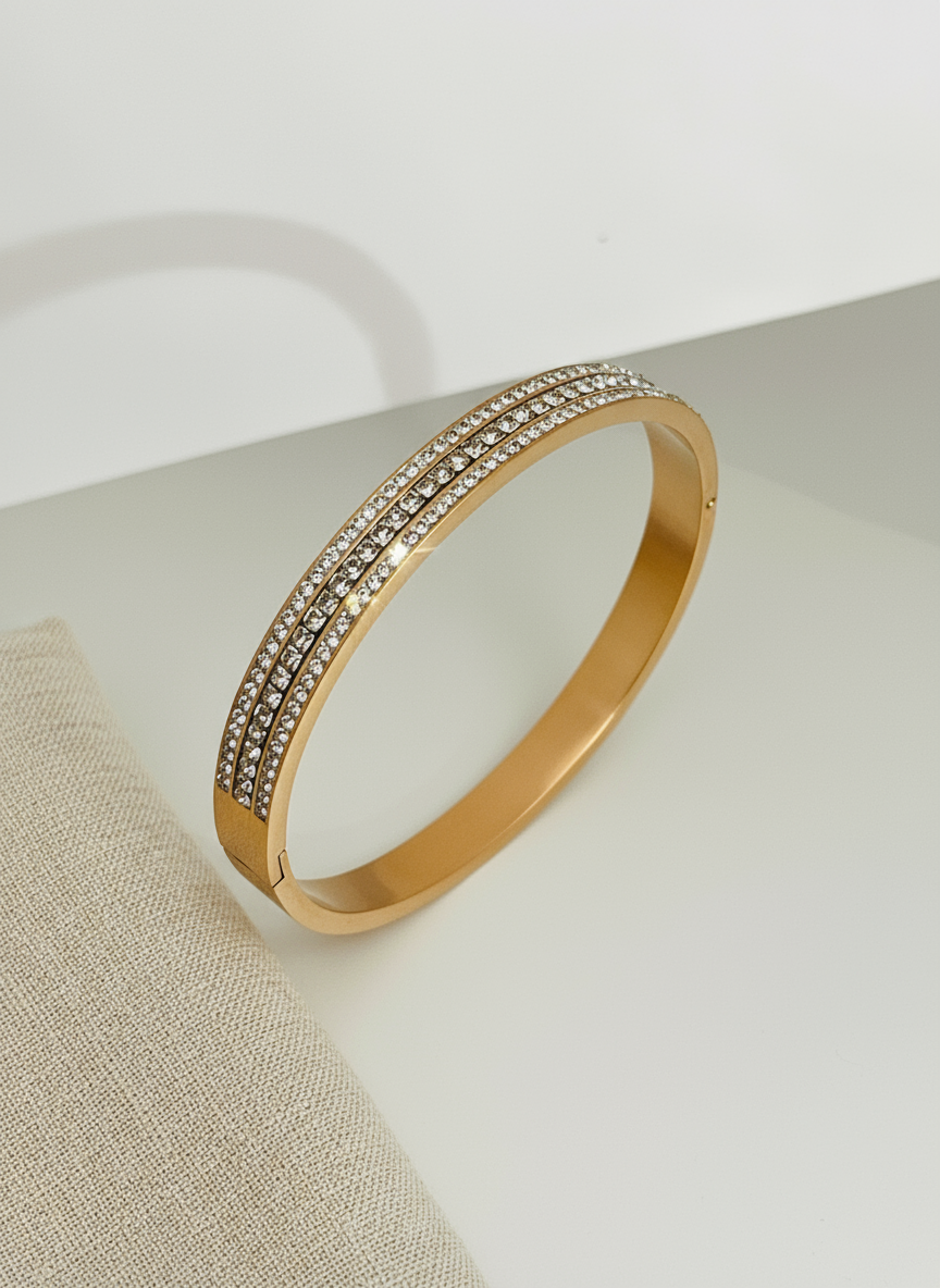 Rose Gold bracelet with embedded stones on a light background