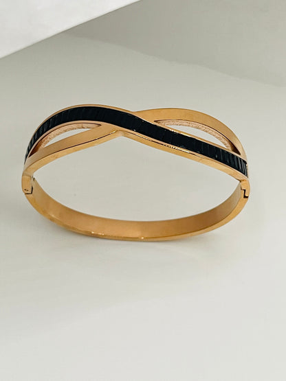 Rose Gold and black bracelet on a light gray background