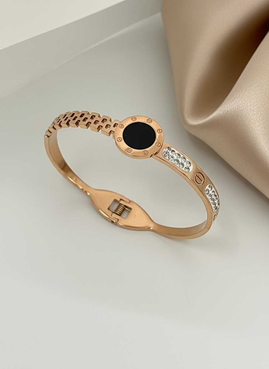 Rose gold bracelet with black gemstone and diamonds on a beige background