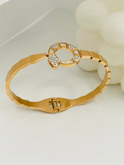 Rose Gold bracelet with intricate design on a white background
