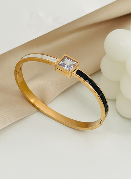 Rose Gold bracelet with a square gemstone on a light background
