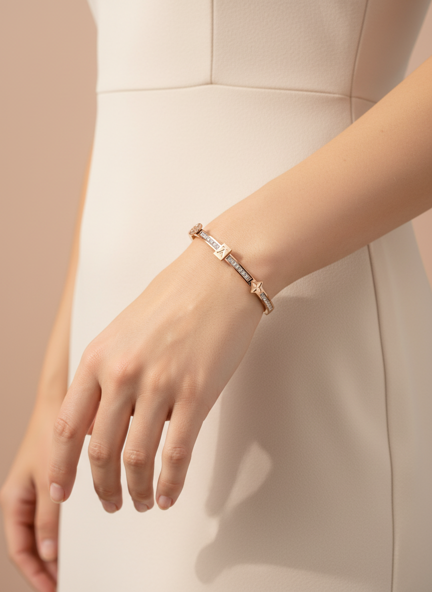 Rose gold bracelet with diamond accents on a light gray background