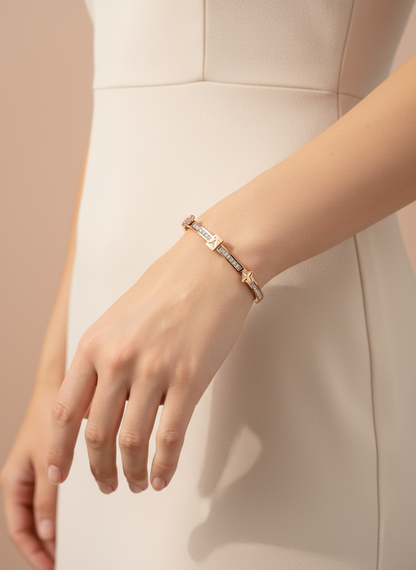 Rose gold bracelet with diamond accents on a light gray background