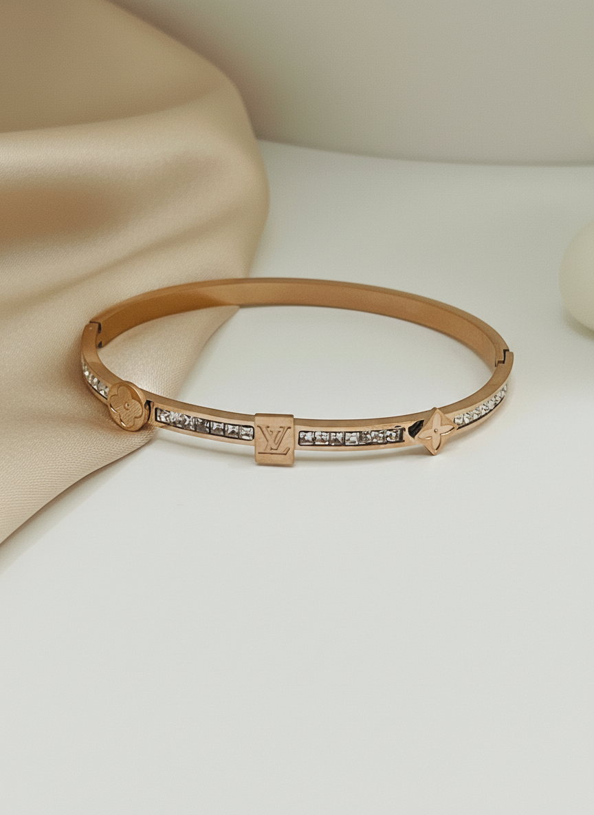 Rose gold bracelet with diamond accents on a beige fabric background