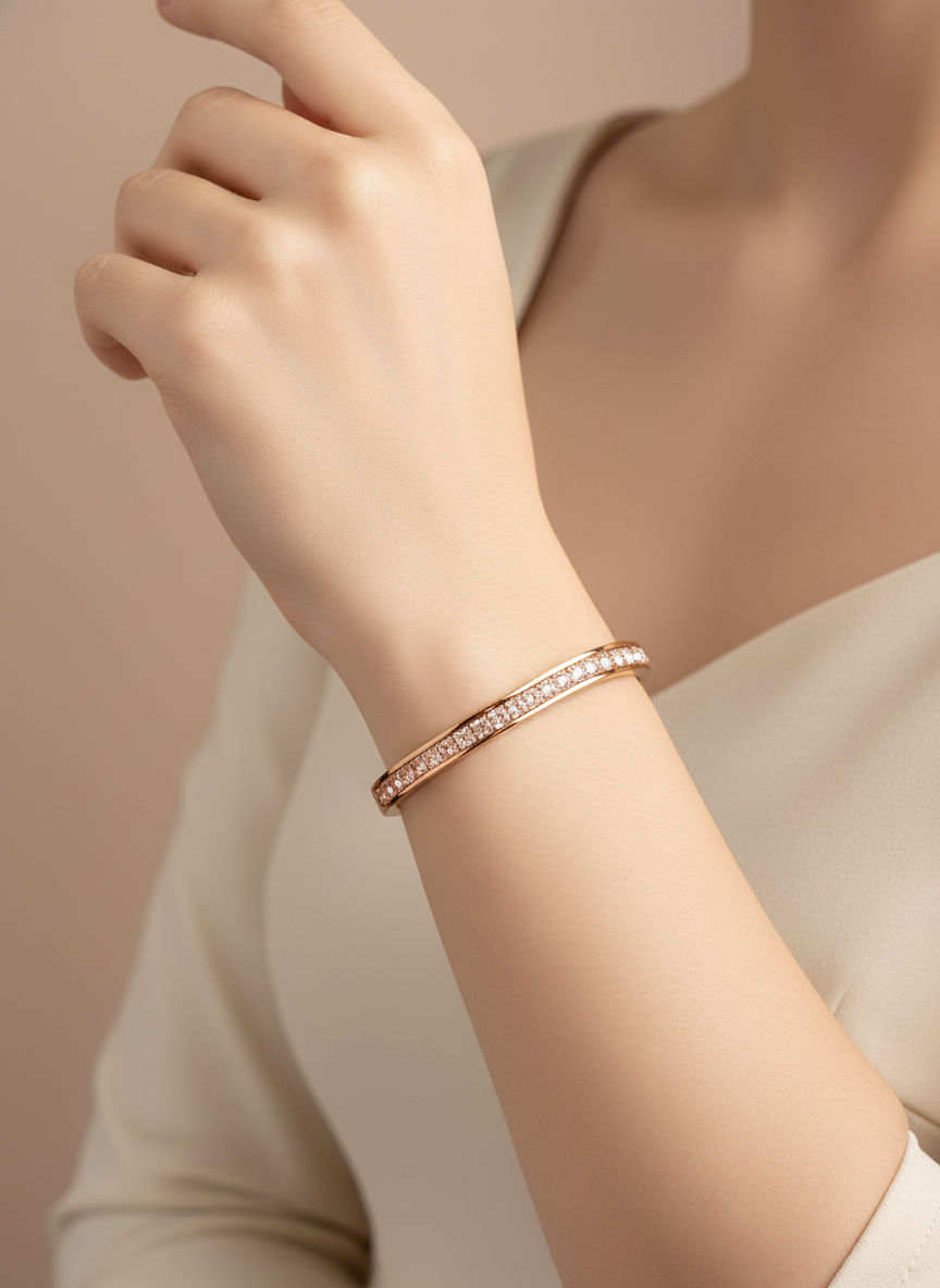 Rose Gold bangle with clear stones on a white background