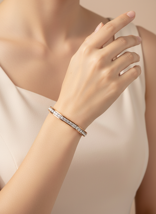 Hand wearing a diamond bracelet on a neutral background