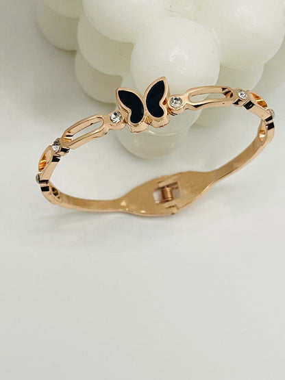 Rose Gold bracelet with a black butterfly charm on a white background