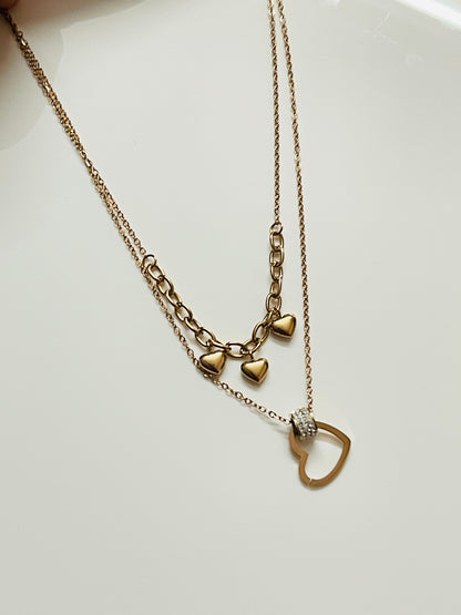Rose Gold necklace with heart-shaped pendants on a white background