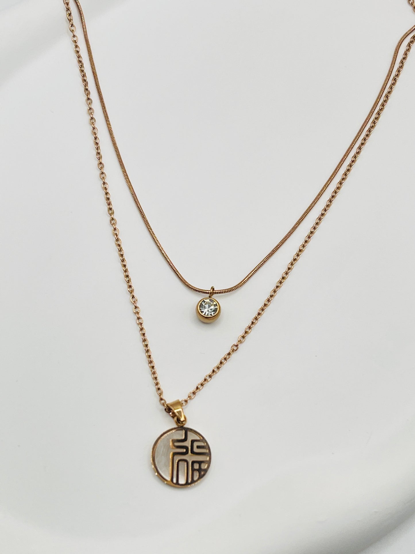 double layer rose gold necklaces with pendants on a white background