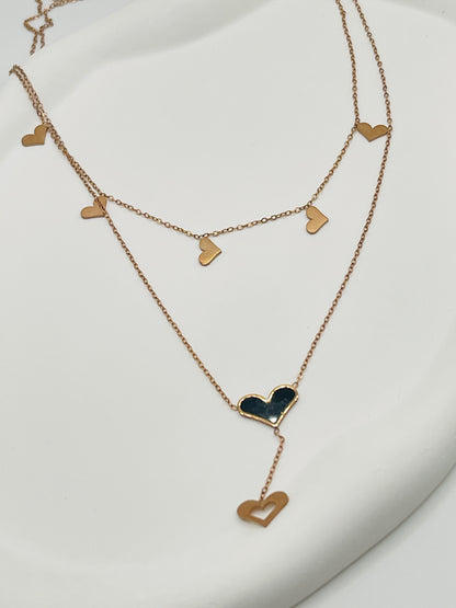 Rose Gold heart-shaped necklace on a white background