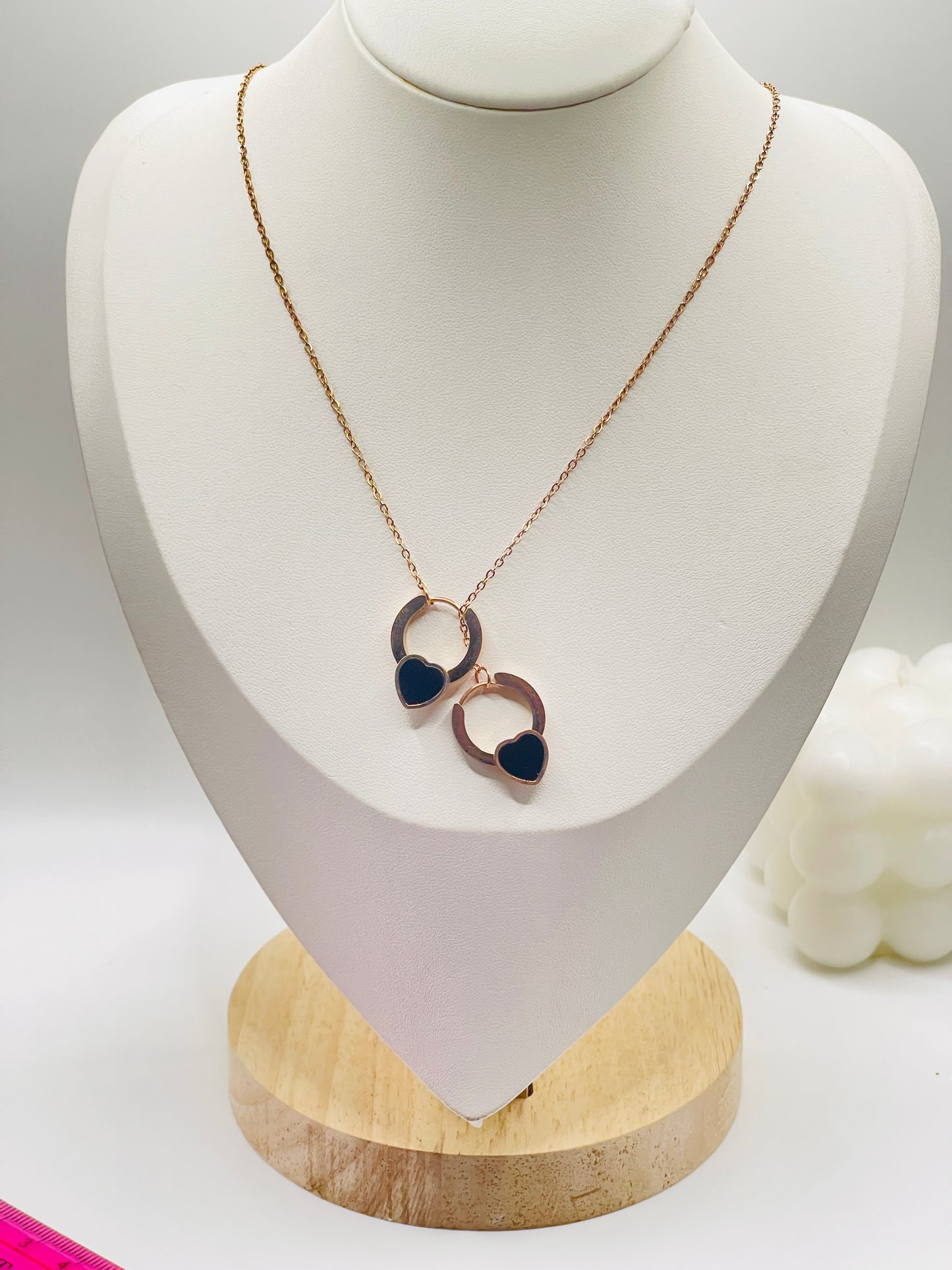 Rose gold Necklace with heart-shaped pendants on a white mannequin bust