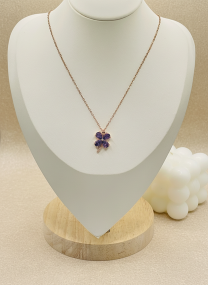 Necklace with a purple pendant on a mannequin bust against a white background