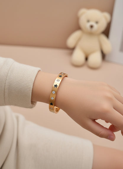 kids Rose gold bangle with star and gemstone designs on a white background