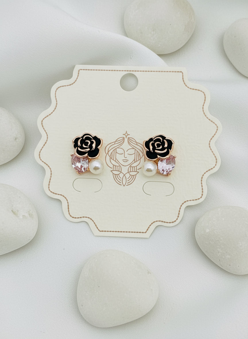 Pair of rose gold and black earrings on a branded card with 'Kiyu Ziyu' logo.
