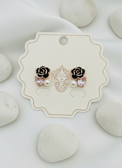 Pair of rose gold and black earrings on a branded card with 'Kiyu Ziyu' logo.