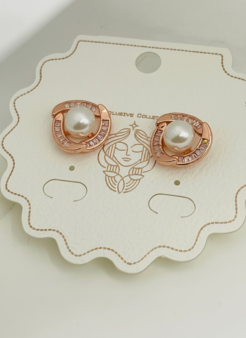 Rose gold earrings with pearls on a Kiyu Ziyu branded card.