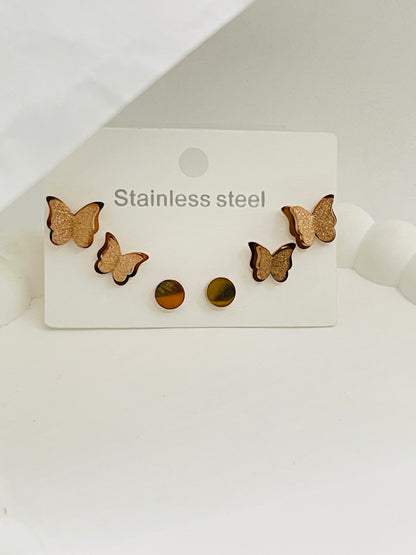 Butterfly-shaped stainless steel earrings on a white card with 'Stainless Steel' text.