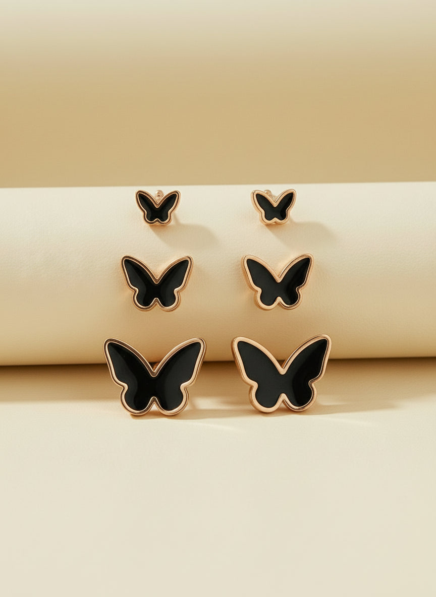 Butterfly-shaped earrings on a white card with 'Stainless steel' text.