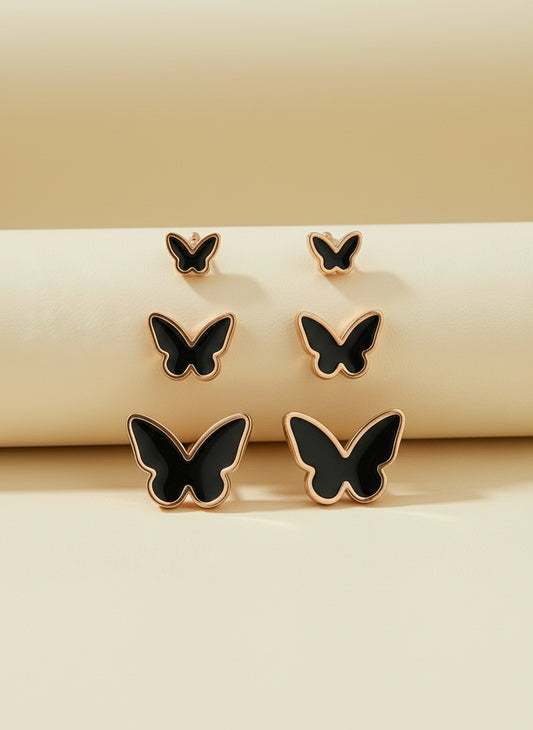 Butterfly-shaped earrings on a white card with 'Stainless steel' text.