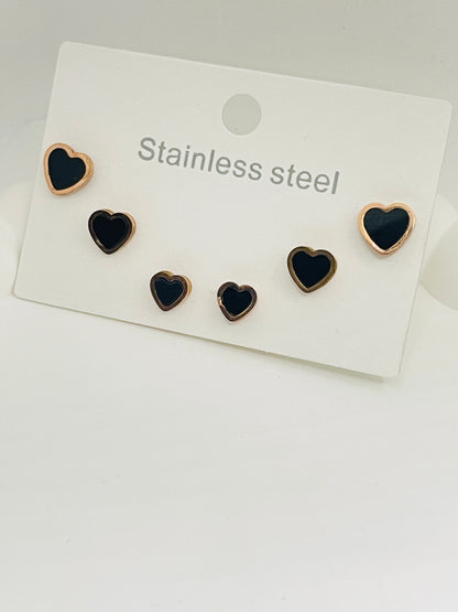 Set of heart-shaped earrings on a white card with 'Stainless steel' text.
