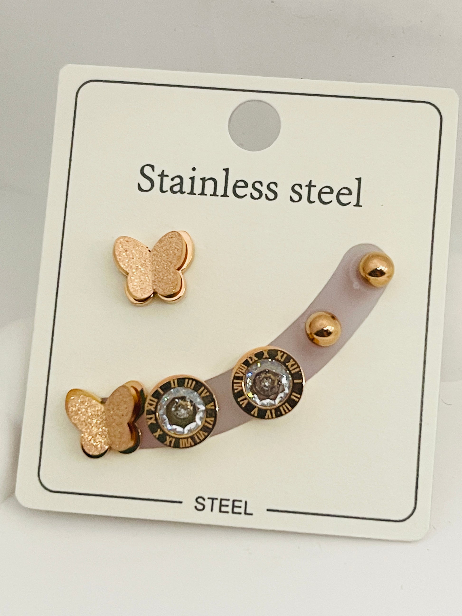 Set of butterfly-themed earrings on a branded card with 'Stainless steel' text.