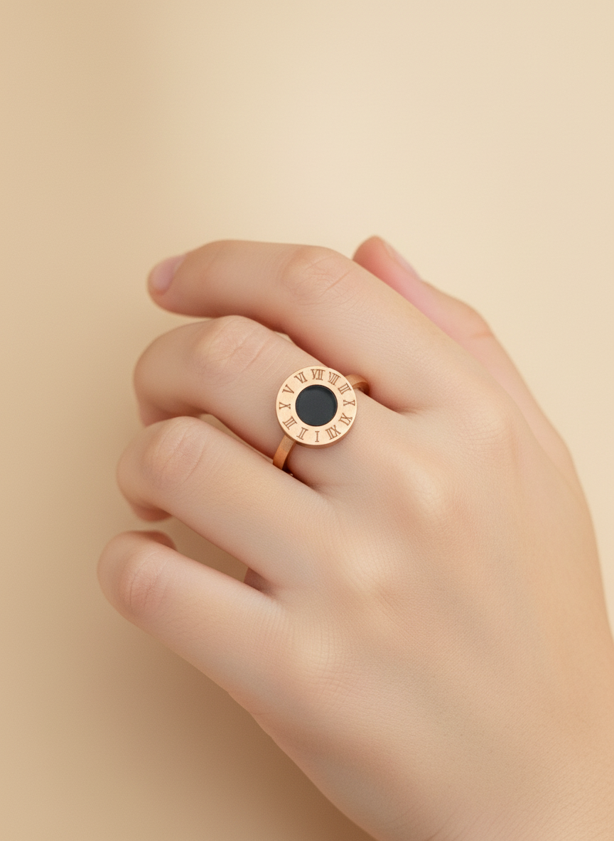 Rose gold ring with a black gemstone on a beige background