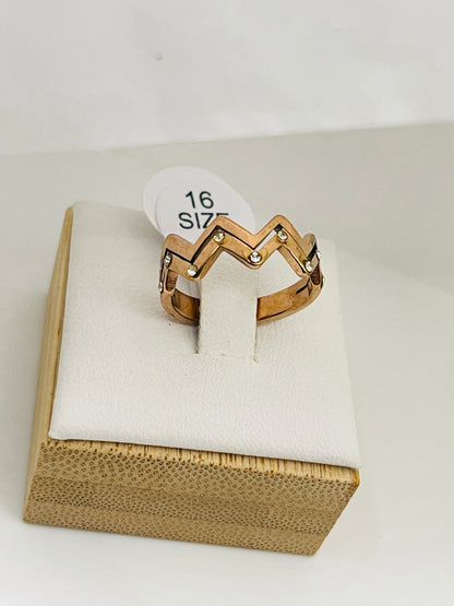 Gold ring on a white cushion with a size label in a wooden box