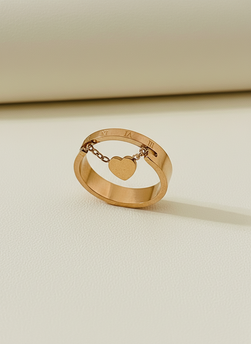Rose Gold ring with a heart charm on a beige background