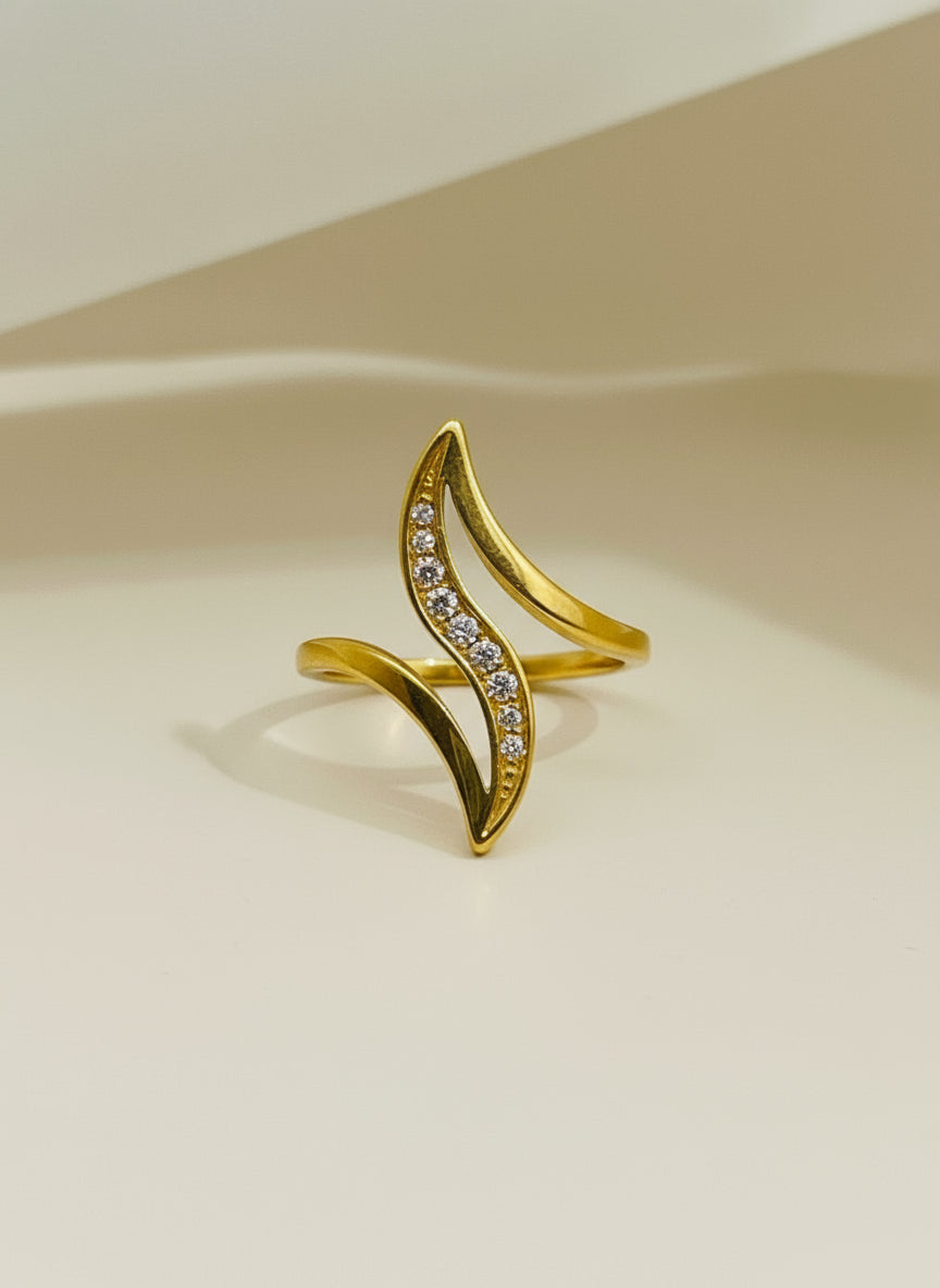 Gold and silver ring on a textured box with a white background