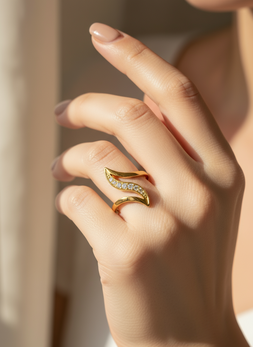 Close-up of a hand wearing a gold ring with a diamond design.