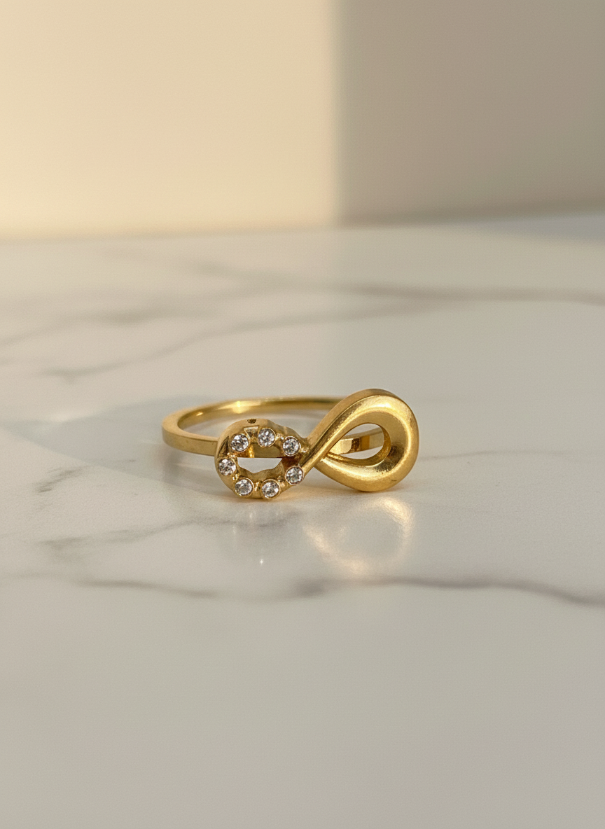 Gold ring with a unique design on a marble surface