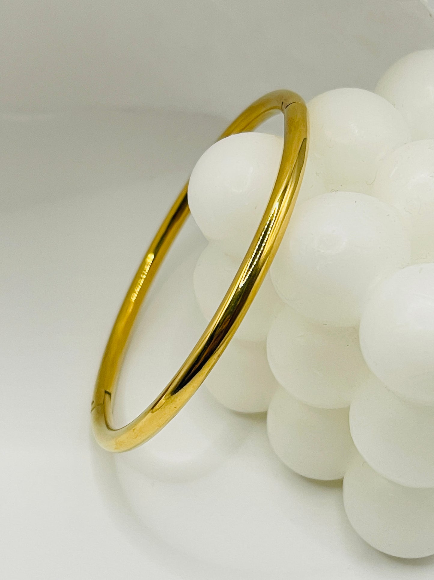 Gold bangle on a white background