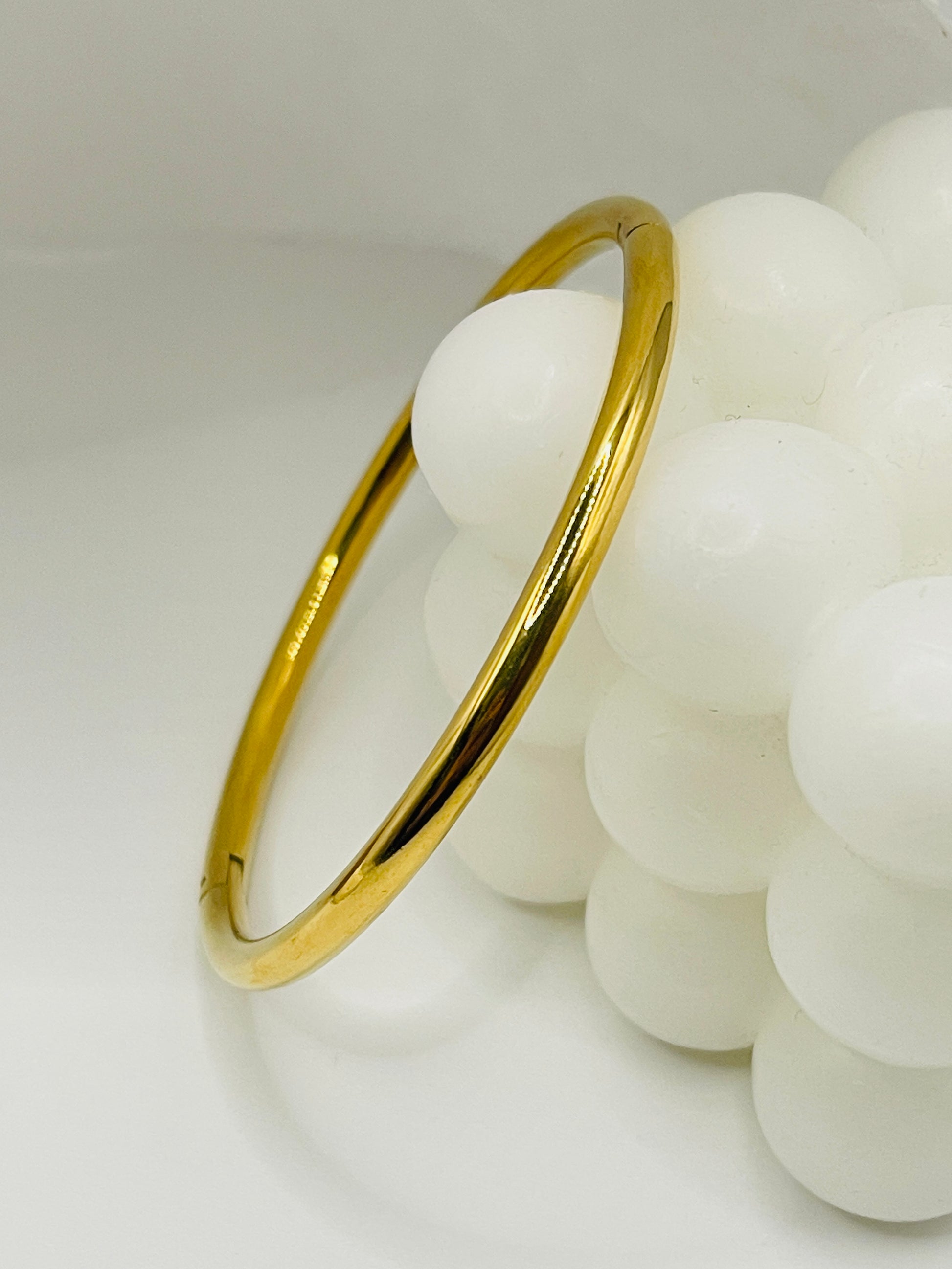 Gold bangle on a white background
