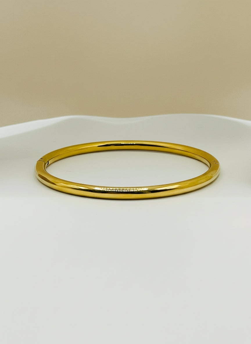 Gold bangle on a white background
