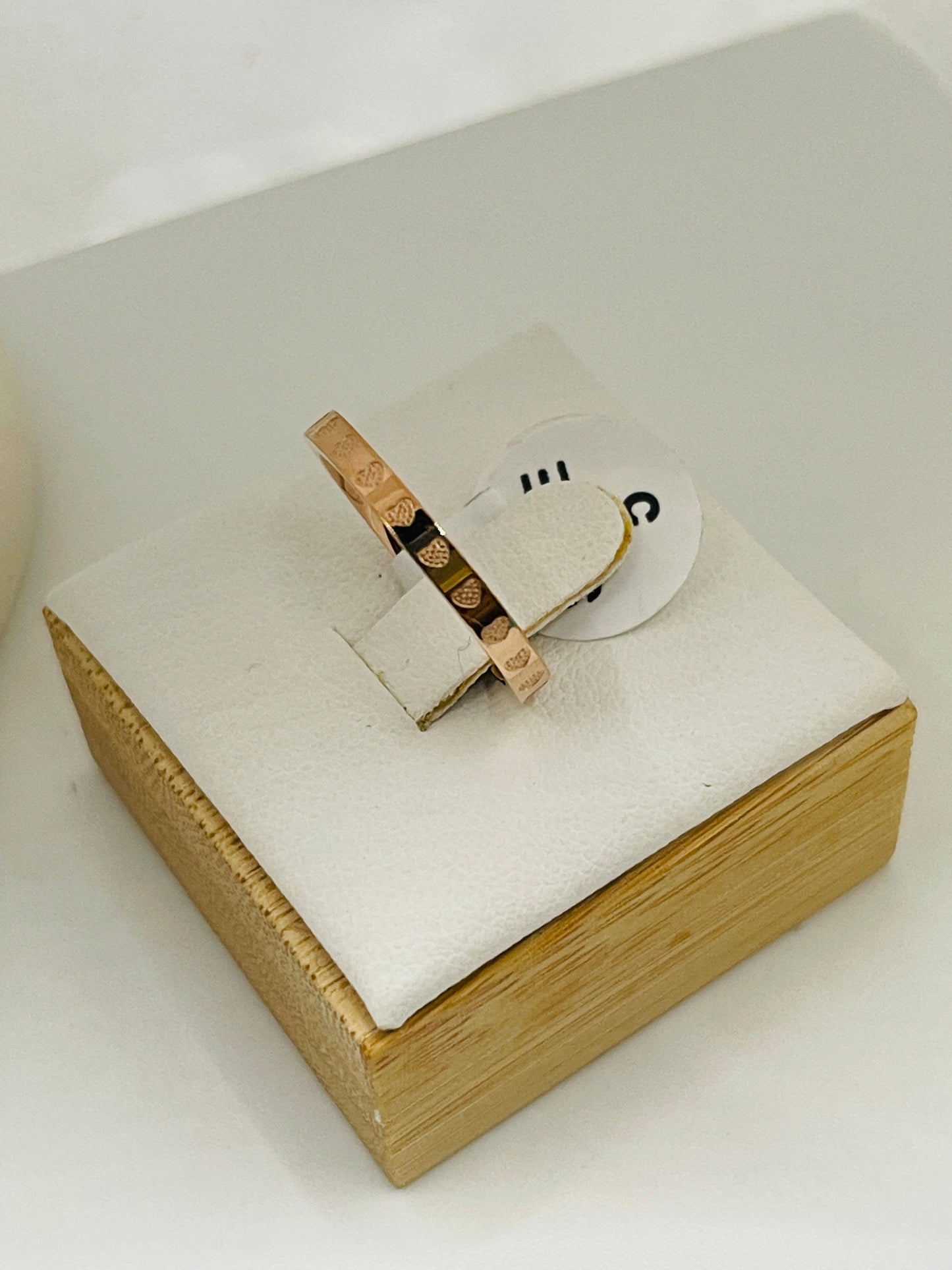 Wooden ring box with a ring on a white background