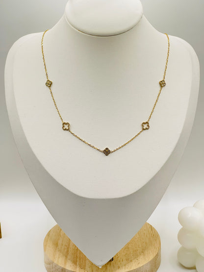 Gold necklace on a white mannequin bust with a wooden base