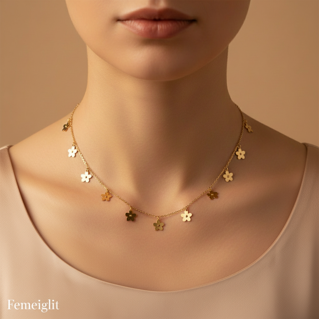 Gold necklace with floral pendants on a model against a beige background, featuring the brand 'Femeiglit'.