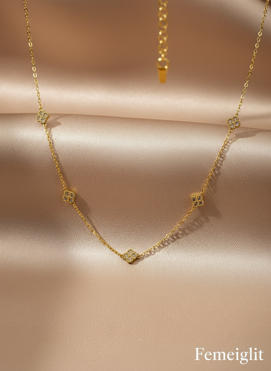 Gold necklace with diamond-like stones on a white mannequin bust.