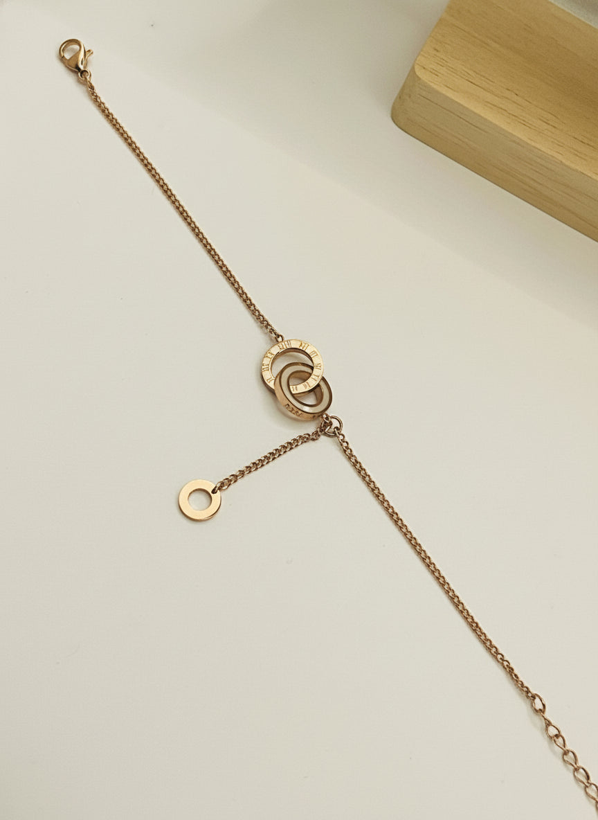 Rose Gold bracelet with a clasp on a light gray background